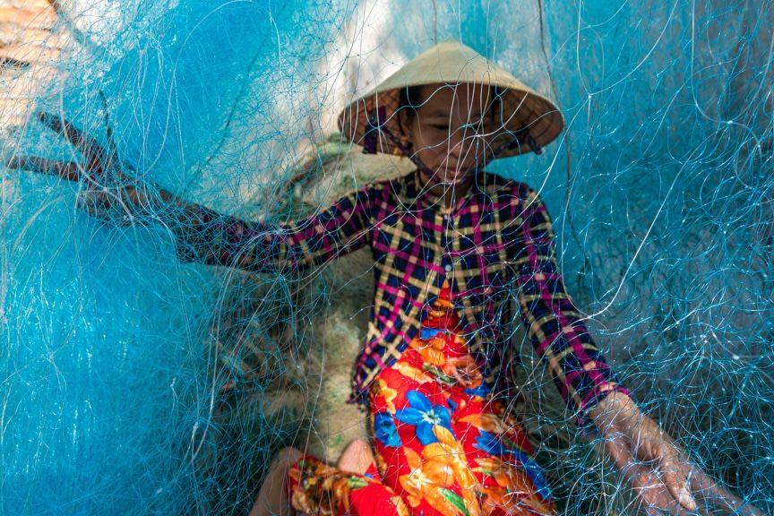person surrounded by fishing nets person surrounded by fishing nets