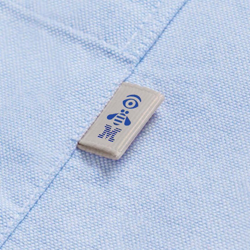 IBM rebus logo in blue on white tag sewn on woven shirt pocket IBM rebus logo in blue on white tag sewn on woven shirt pocket