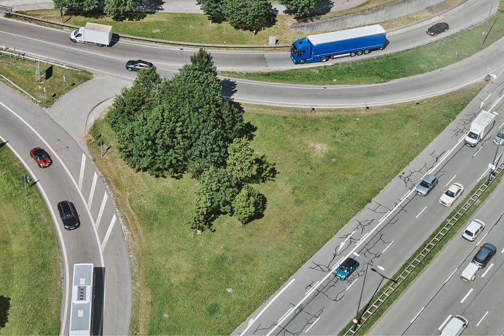 aerial view of highway intersection with cars and trucks aerial view of highway intersection with cars and trucks