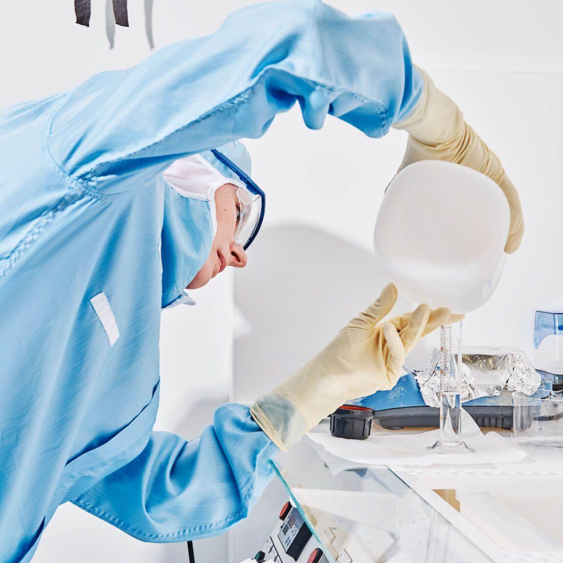 portrait of person in clean room pouring liquid portrait of person in clean room pouring liquid