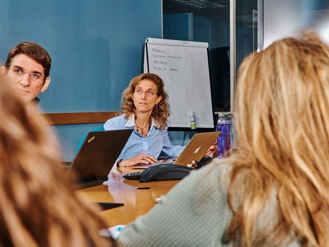 people working around conference table one person in focus people working around conference table one person in focus