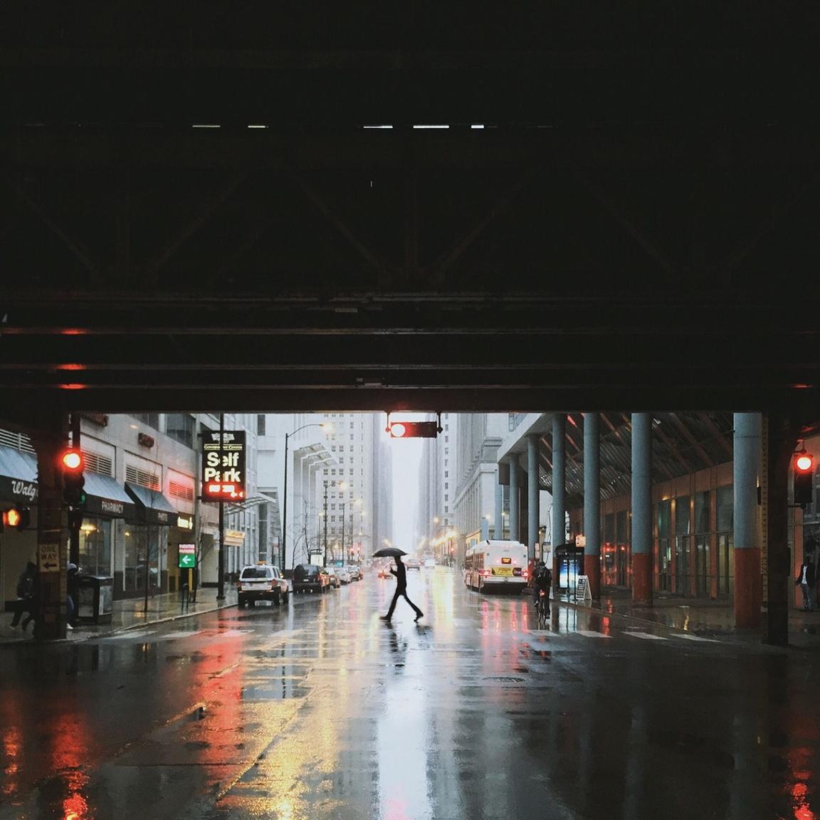 person crossing rainy city street person crossing rainy city street