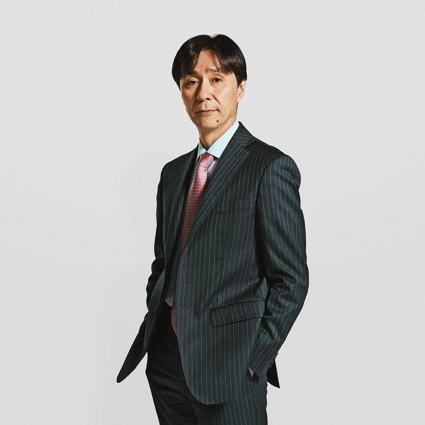portrait of executive wearing suit with hands in pockets portrait of executive wearing suit with hands in pockets
