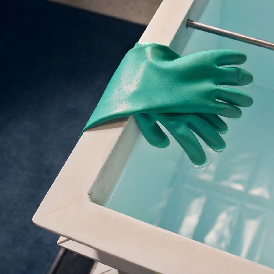 green gloves in clean room setting green gloves in clean room setting