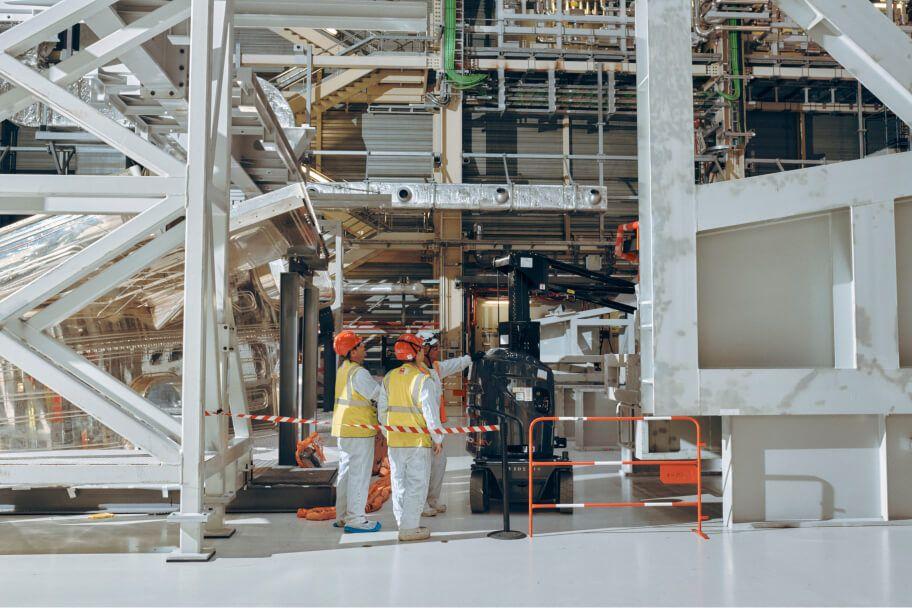 workers in industrial setting wearing safety gear workers in industrial setting wearing safety gear