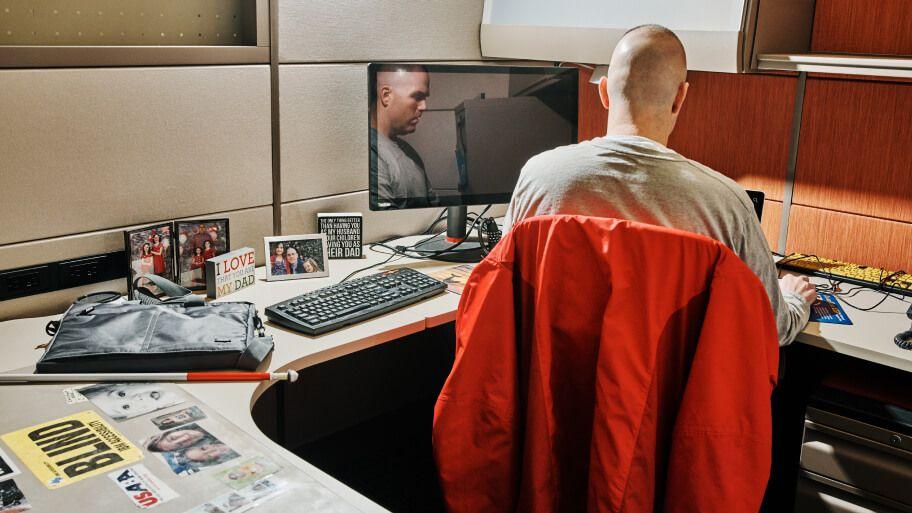 blind employee seated at dedicated workstation blind employee seated at dedicated workstation